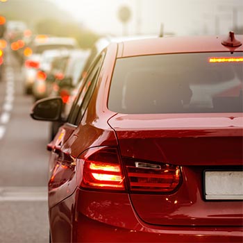 Rear view of modern car with brake lights on during rush hour